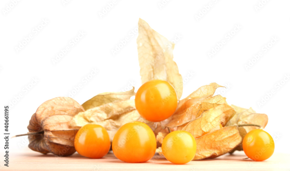 Physalis heap on wooden table on white background Physalis heap on wooden table on white background
