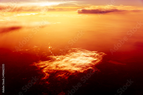 Red sky, sunset and  clouds. Flying over Clouds
