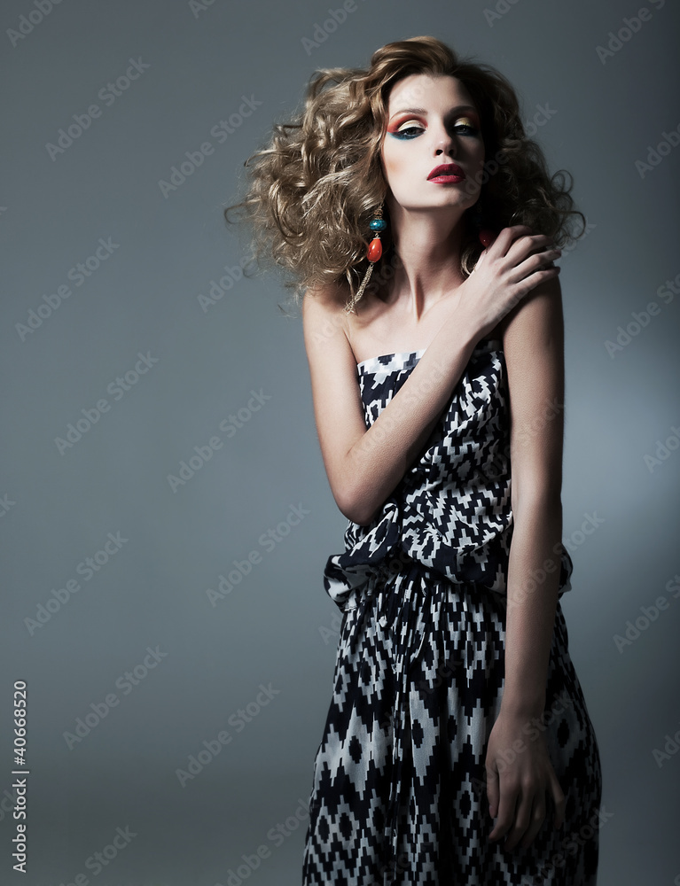Fototapeta premium Beautiful emotional bright woman over dark background posing