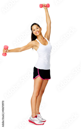 Attractive asian woman lifts dumbbells overhead,