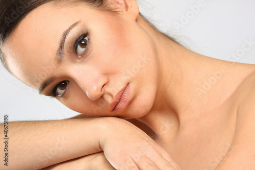 Young woman with healthy complexion looking at camera