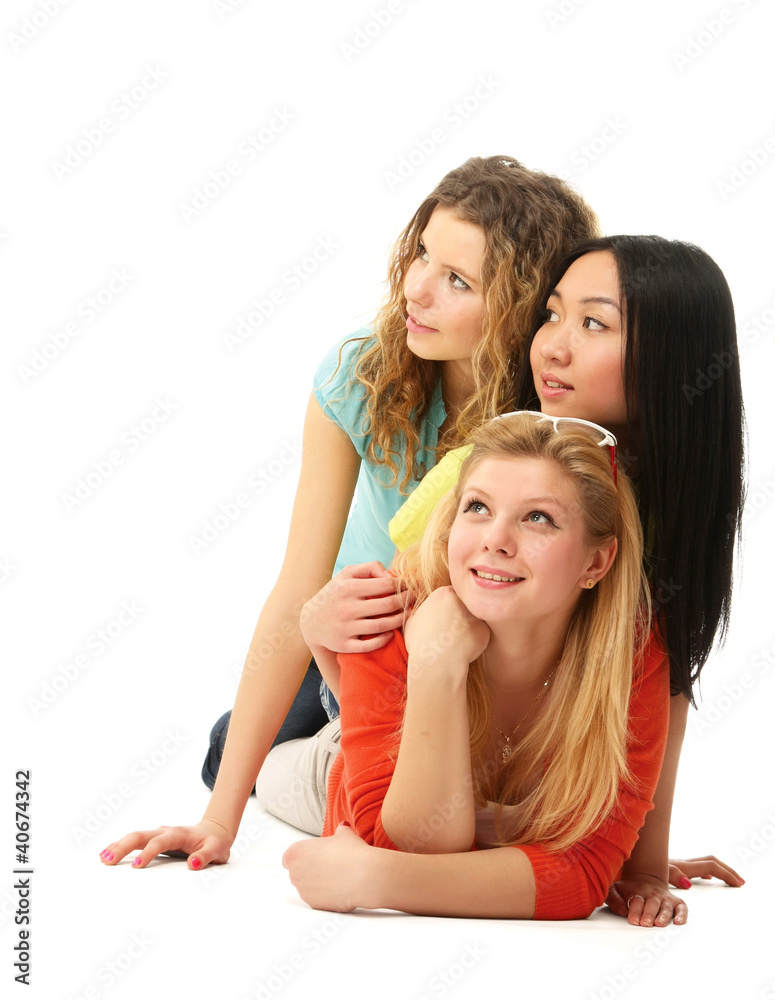 Diverse group of three girls lying on floor Diverse group of three girls lying on floor
