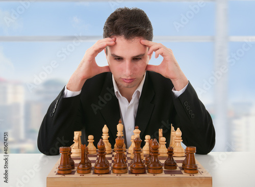 serious man thinks on game of chess