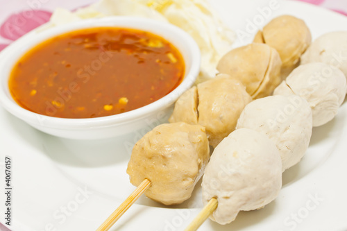 Fried balls chili sauce on white background.