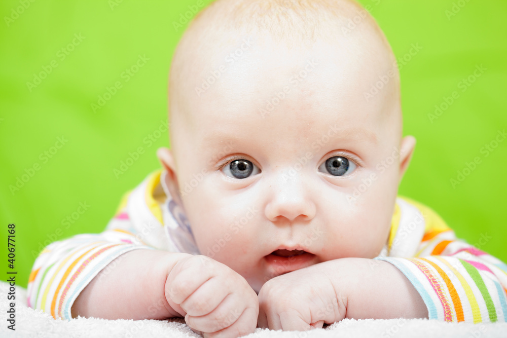 Portrait of baby on a green background Portrait of baby on a green background
