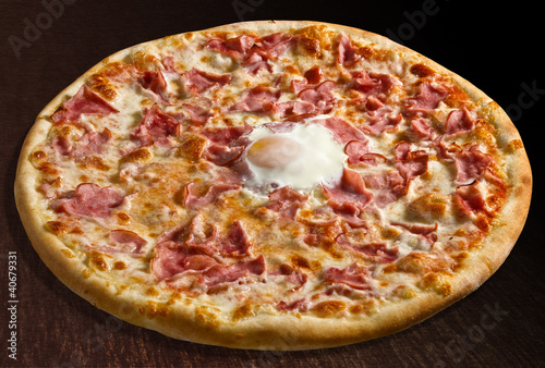 Pizza o sole mio with baked egg and ham - isolated photo