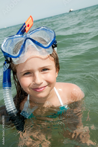Summer vacation - little girl snorkeling in the sea