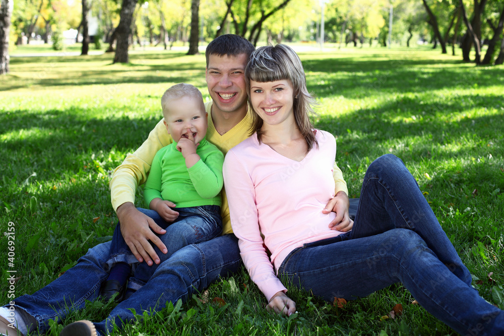 Young family with a child in summer park Young family with a child in summer park