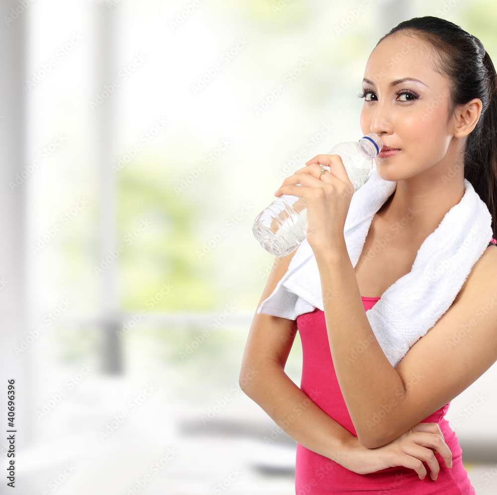 attractive asian smiling woman drinking water attractive asian smiling woman drinking water