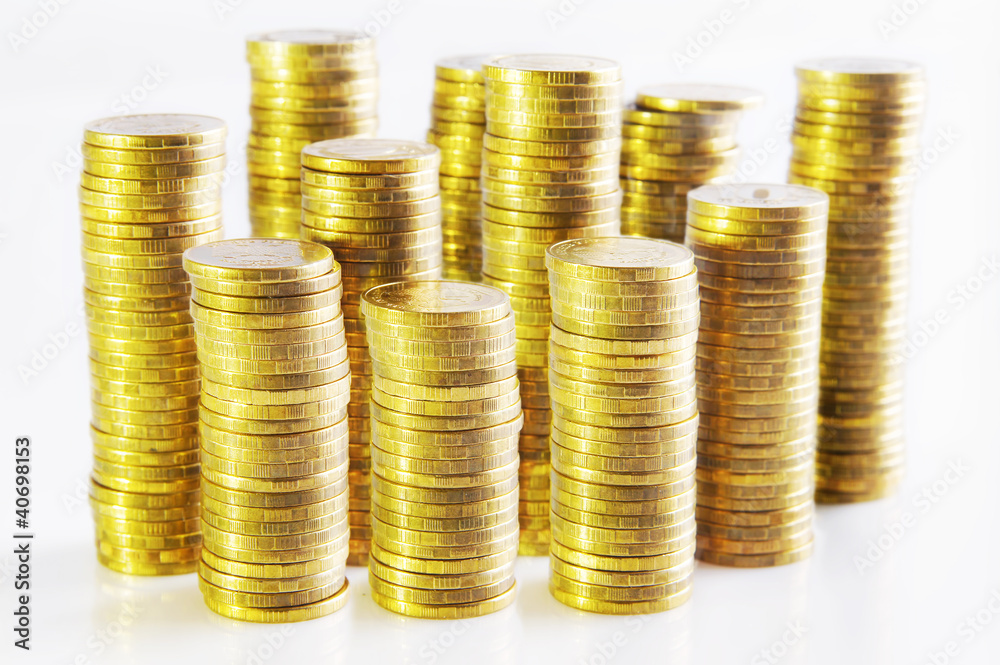 Piles of gold coins against white background Piles of gold coins against white background