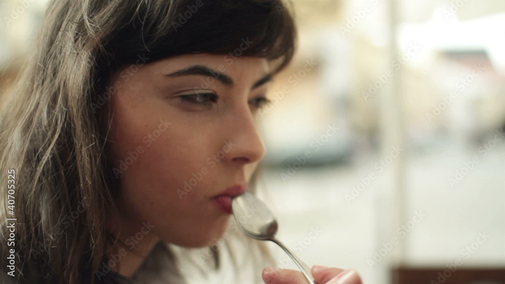 Happy woman eating tasty dessert in cafe, steadicam shot Happy woman eating tasty dessert in cafe, steadicam shot