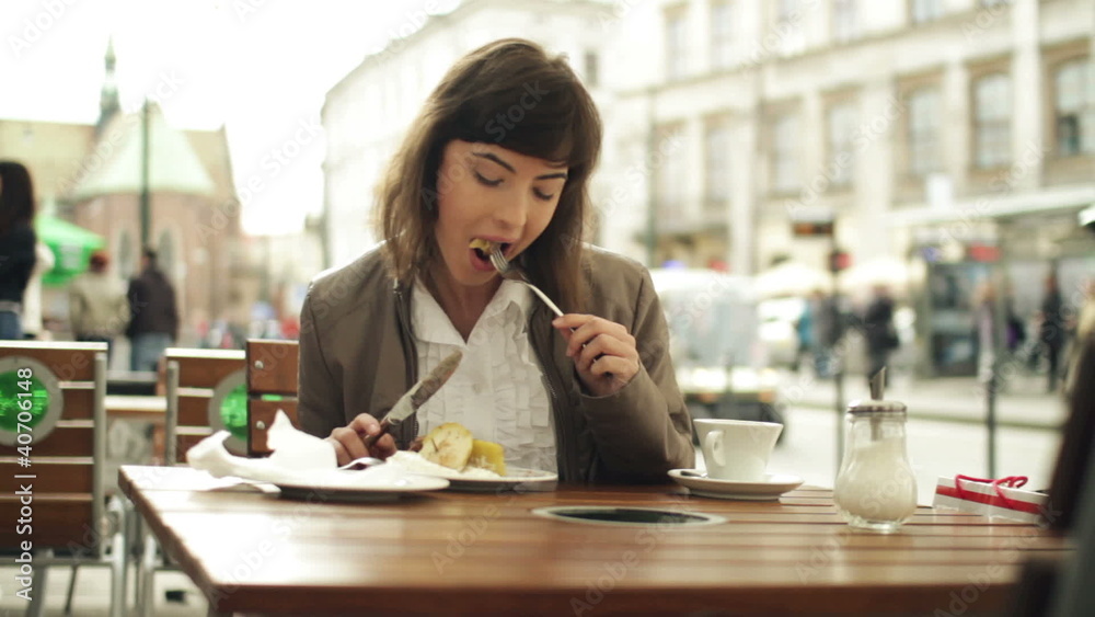 Happy woman eating tasty dessert in cafe, steadicam shot Happy woman eating tasty dessert in cafe, steadicam shot