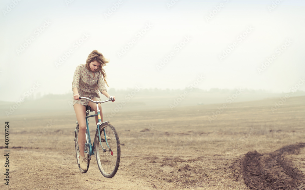 Fototapeta premium beautiful girl rides a bicycle