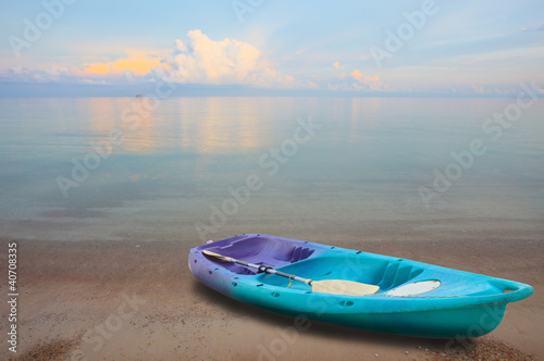 green sea  kayak and blade on the smooth sea beach