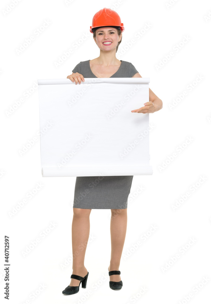 Happy architect woman pointing on blank flip chart isolated Happy architect woman pointing on blank flip chart isolated