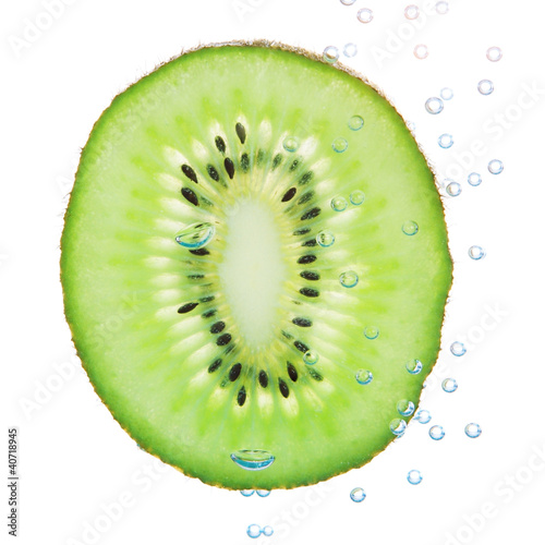Kiwi in a liquid with bubbles. On a white background.