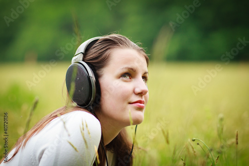 portrait of a pretty young woman listening to music on her mp3 p