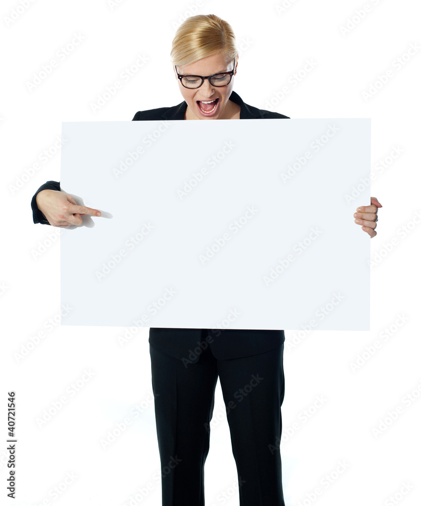 Successful business female pointing at white blank billboard Successful business female pointing at white blank billboard