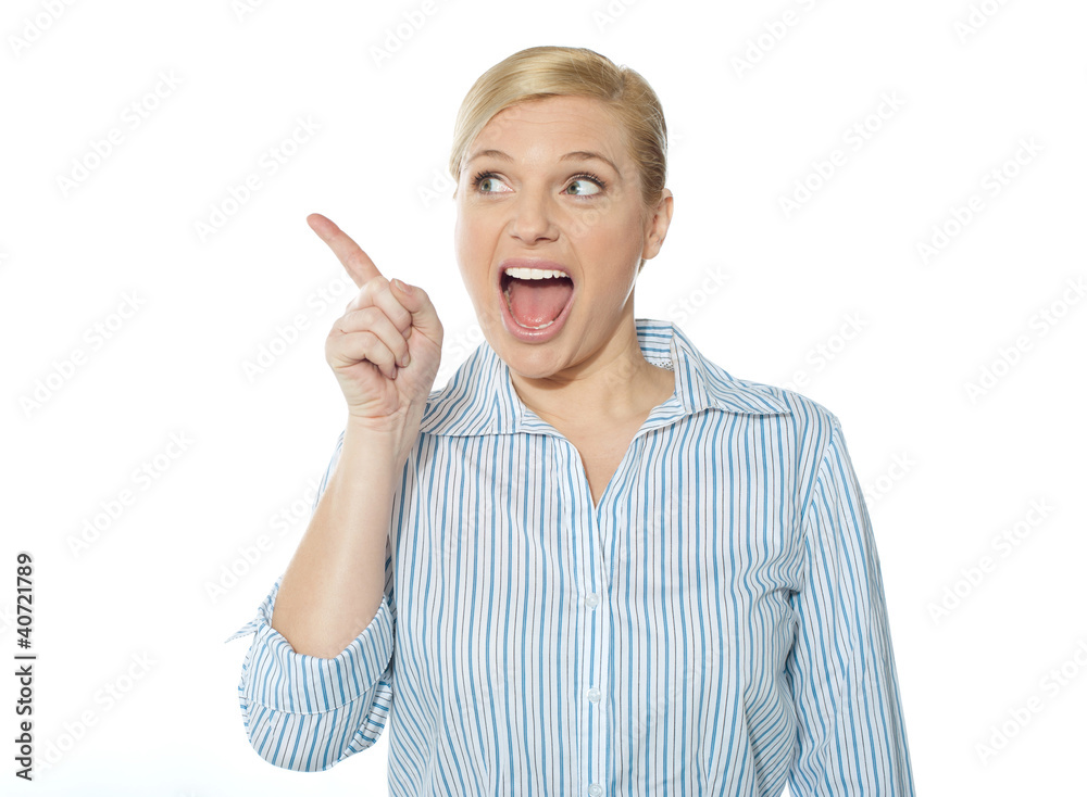 Excited female business executive pointing away Excited female business executive pointing away
