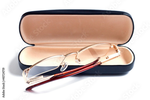 a glasses of gold color and case to them