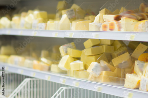 Variety of cheeses  pieces on shelves in supermarket