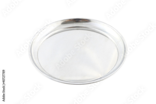 Round stainless food plate on white background.