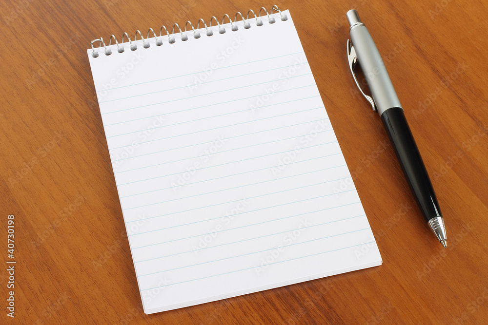 Notepad and pen on wooden background Notepad and pen on wooden background