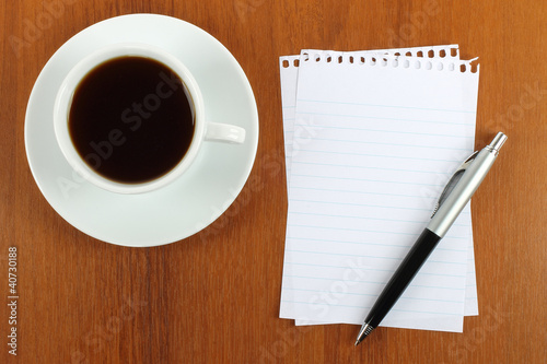 Cup of coffee  paper and pen on wooden background