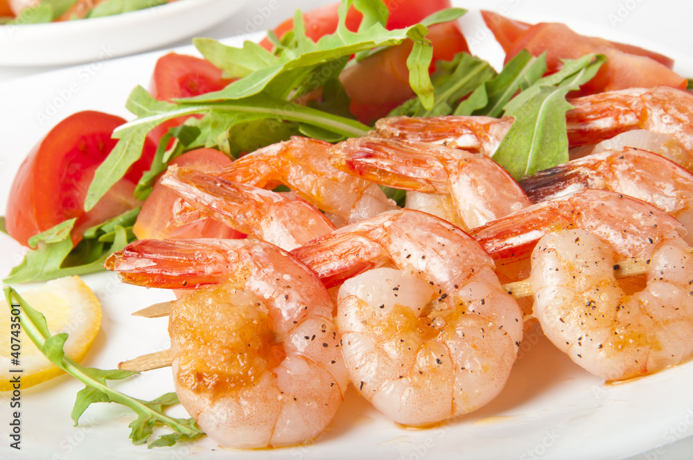 Fresh grilled shrimps with lemon on white plate Fresh grilled shrimps with lemon on white plate