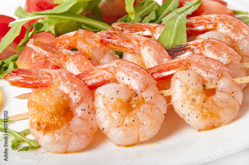 Fresh grilled shrimps with lemon on white plate