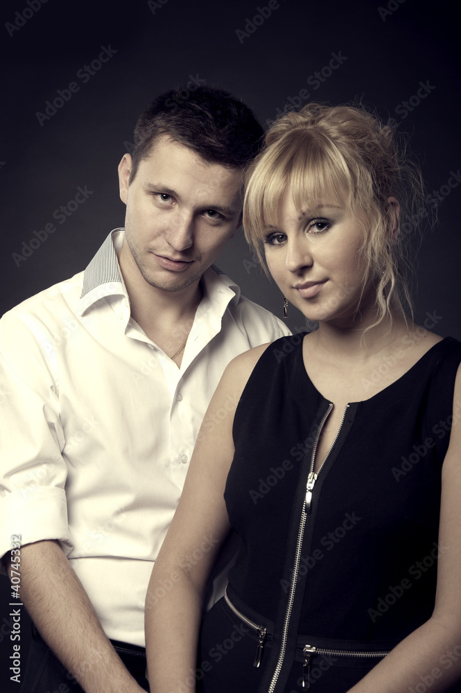 Fototapeta premium close up portrait of a young couple together on black background