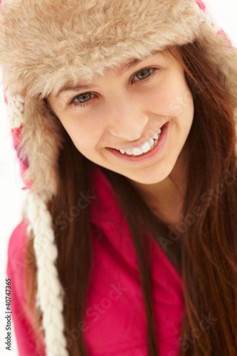 Portrait Of Teenage Girl In Snow Wearing Fur Hat