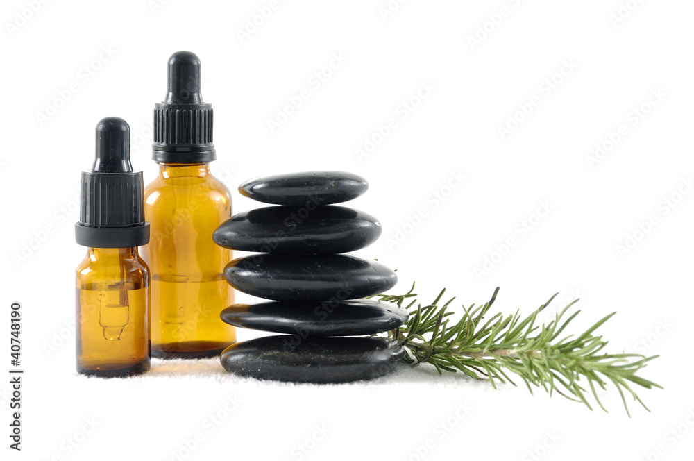 Stacked of stones with oil and fresh green leaves Stacked of stones with oil and fresh green leaves
