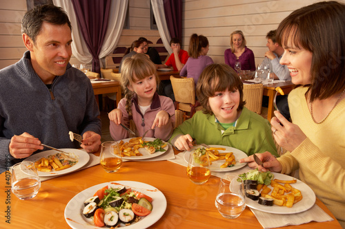 Family Eating Lunch Together In Restaurant