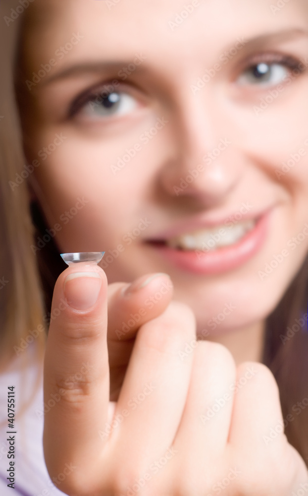 A girl holds a contact lens A girl holds a contact lens