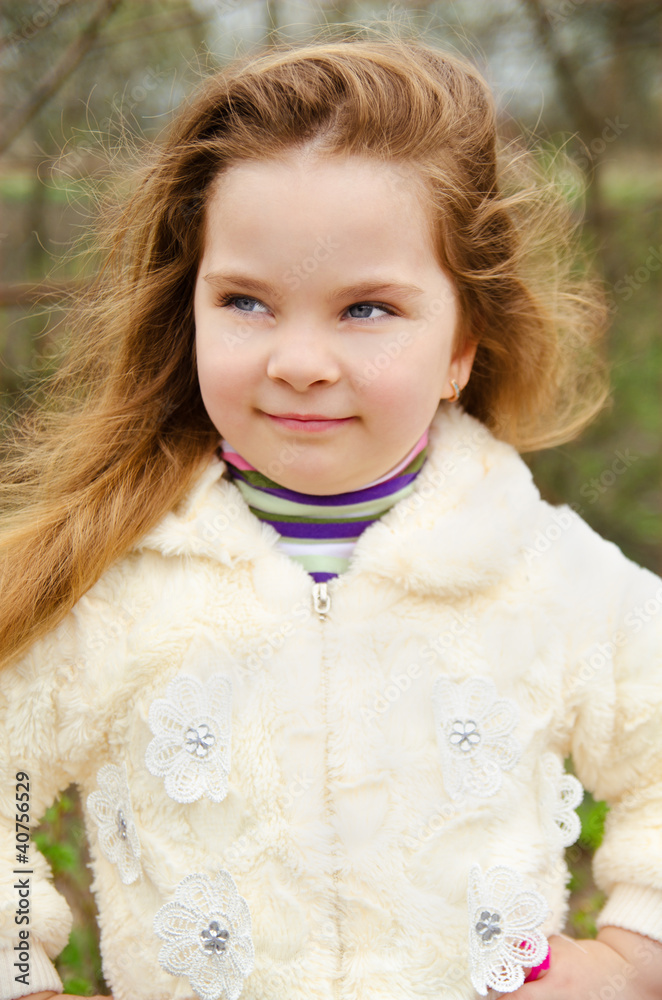 Portrait of smiling little girl outdoors on a spring day Portrait of smiling little girl outdoors on a spring day
