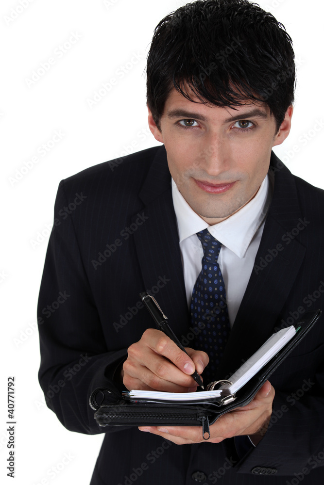 handsome young businessman with agenda handsome young businessman with agenda