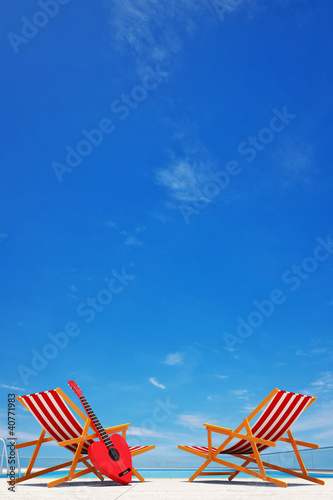 swimming pool with 2 beach chairs