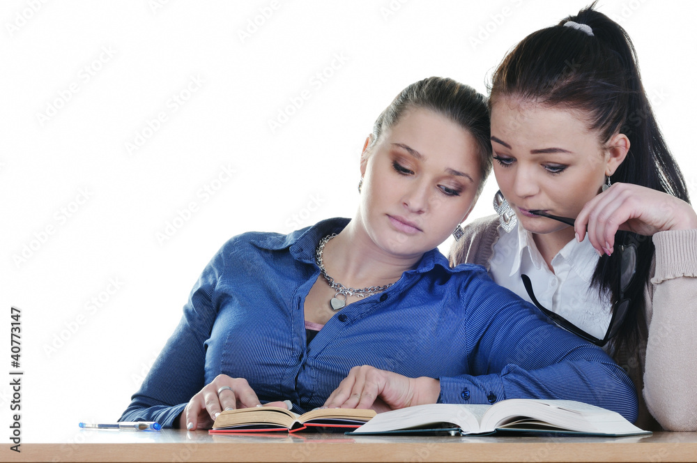 Two students tired of books at the table Two students tired of books at the table