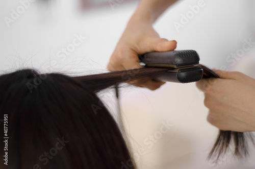 Closeup of a woman getting her hair straightened