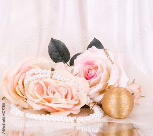 Vintage beads with roses and candle on white background