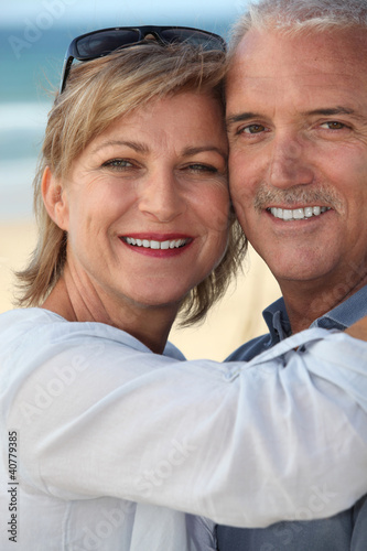 happy mature couple at beach