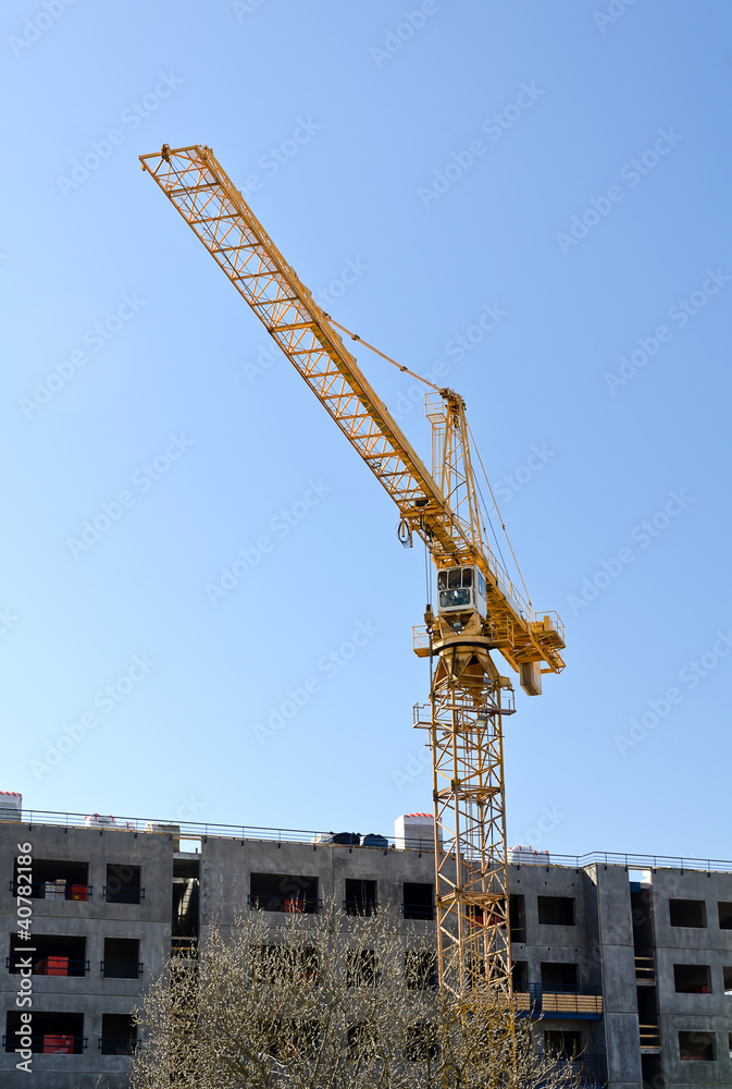 Tower crane near building under construction Tower crane near building under construction