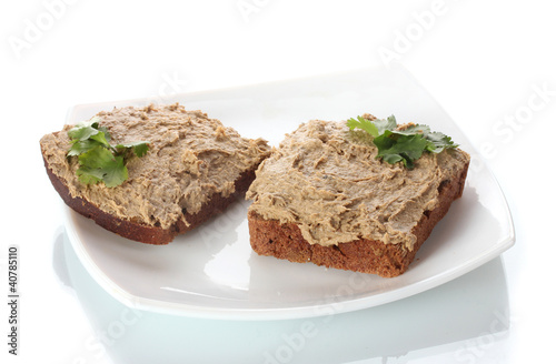 Fresh pate on bread on white plate isolated on white