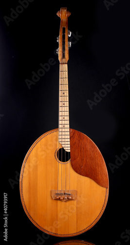 Retro kobza- Ukrainian musical instrument on black background photo