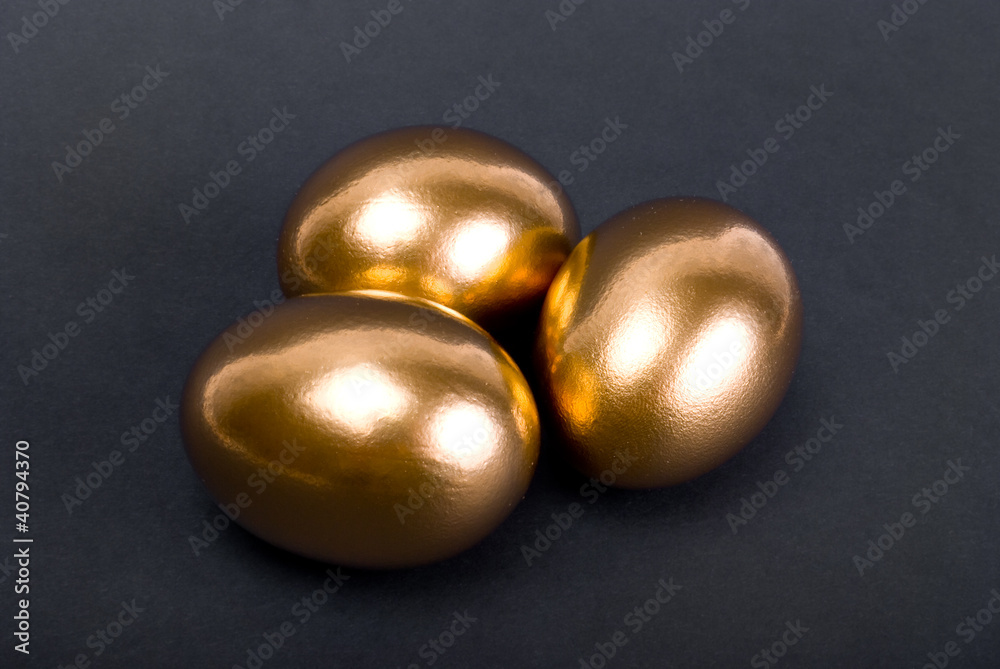 Golden eggs. A symbol of making money and successful investment Golden eggs. A symbol of making money and successful investment