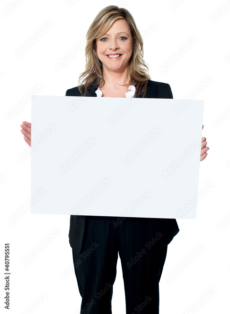 Smiling woman holding a blank billboard Smiling woman holding a blank billboard