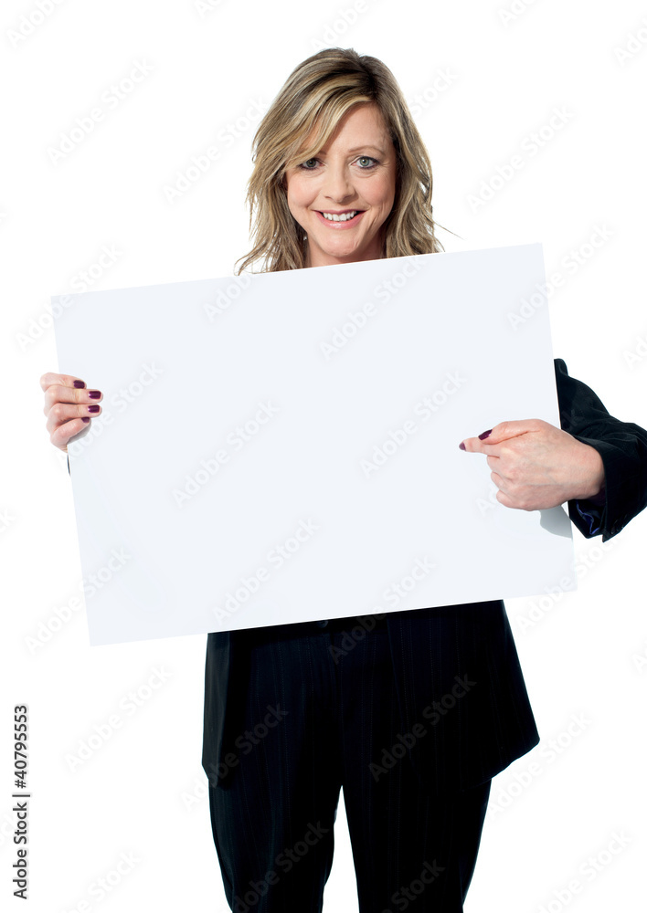 Beautiful woman pointing at the blank billboard Beautiful woman pointing at the blank billboard