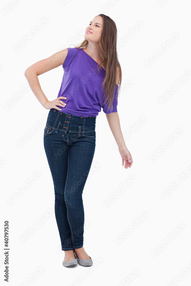 Teenager looking far ahead to her side with her hand on her hip Teenager looking far ahead to her side with her hand on her hip