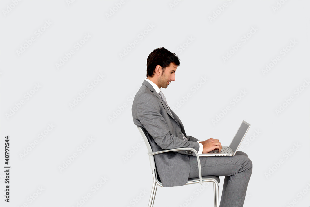 Businessman sitting on chair in front of laptop Businessman sitting on chair in front of laptop